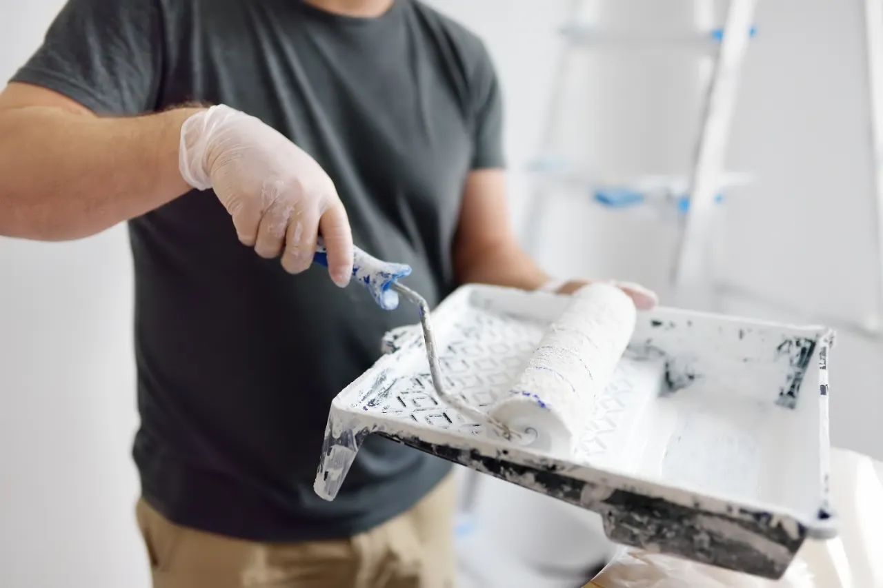 Painter rolling interior wall in a New York home